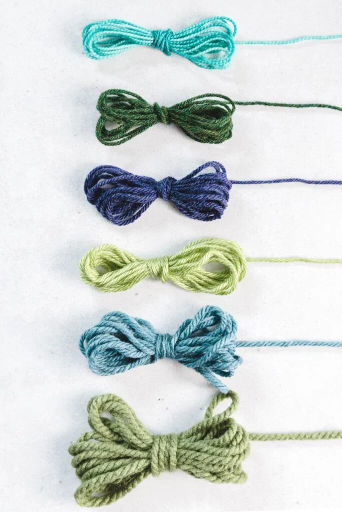 Yarns arranged from lace weight to bulky weight, showing the difference in thickness.